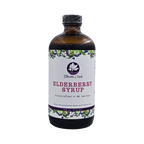Front view of Blossom Creek 16 oz handcrafted Elderberry Syrup in an amber glass bottle with a white floral and elderberry label, made in North Georgia.