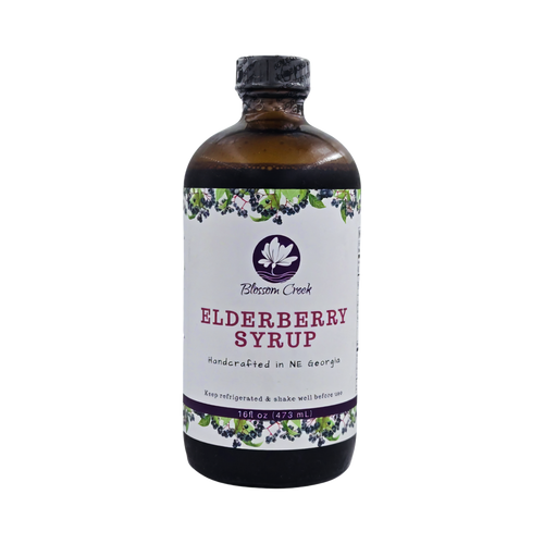 Front view of Blossom Creek 16 oz handcrafted Elderberry Syrup in an amber glass bottle with a white floral and elderberry label, made in North Georgia.