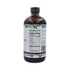Side view of Blossom Creek 16 oz Elderberry Syrup in an amber glass bottle, featuring the white label with purple and green elderberry illustrations and Nutrition Facts panel.