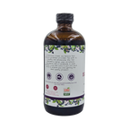Side view of Blossom Creek 16 oz Elderberry Syrup in an amber glass bottle, featuring the white label with our company story, purple elderberry illustrations, and Georgia Grown logo.
