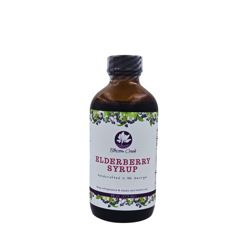 Front view of Blossom Creek 8 oz handcrafted Elderberry Syrup in an amber glass bottle with a white floral and elderberry label, made in North Georgia.